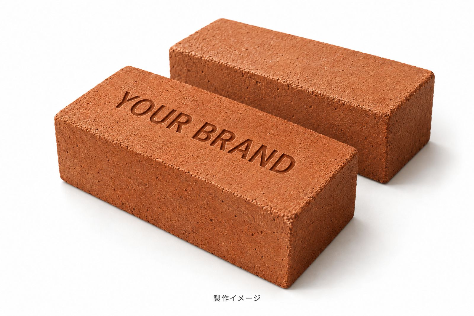 「YOUR BRAND」の文字が刻印された赤褐色のレンガと、無地のレンガが並ぶ製作イメージ